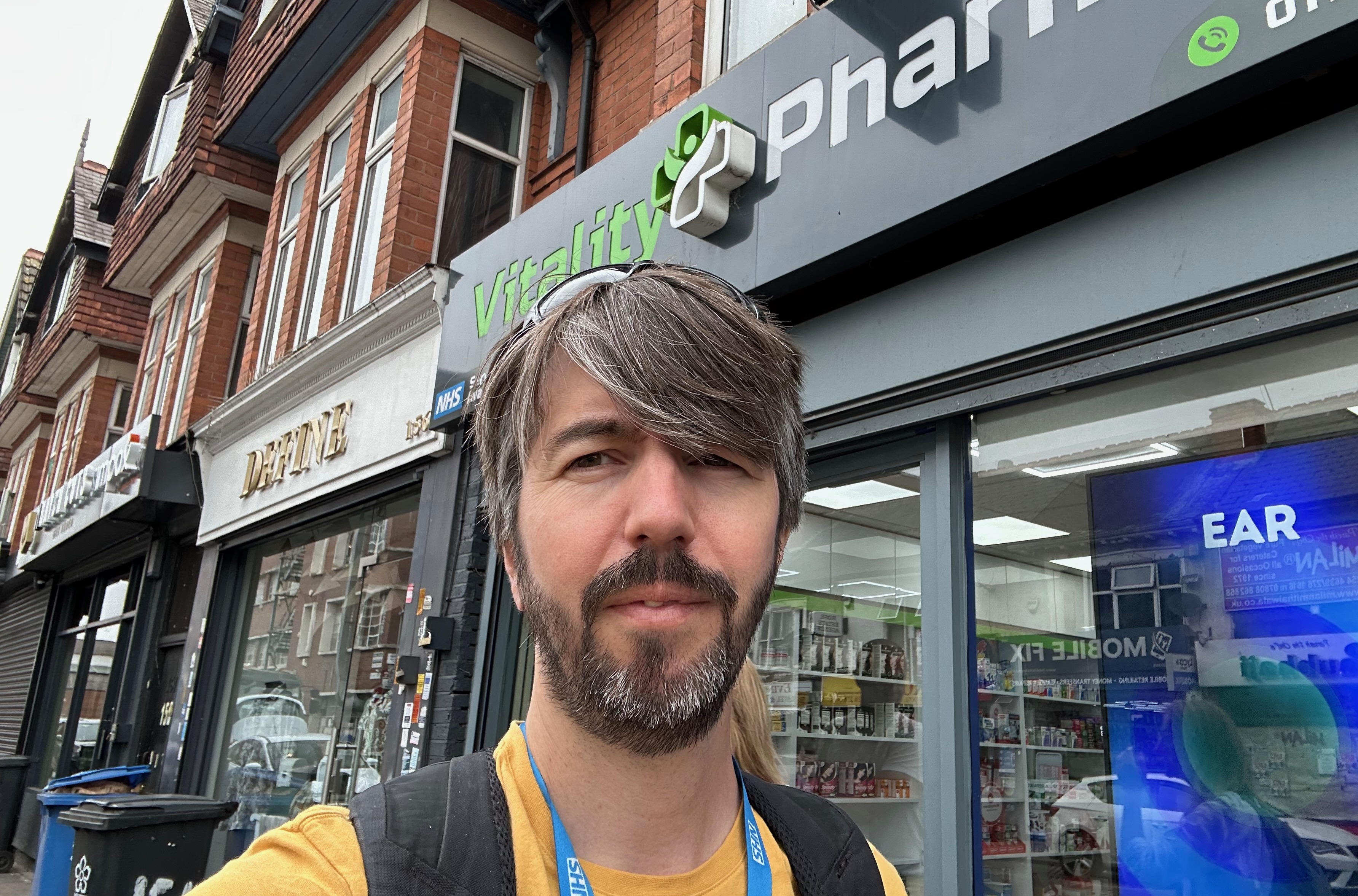 Photo of me stood outside a pharmacy on a high street