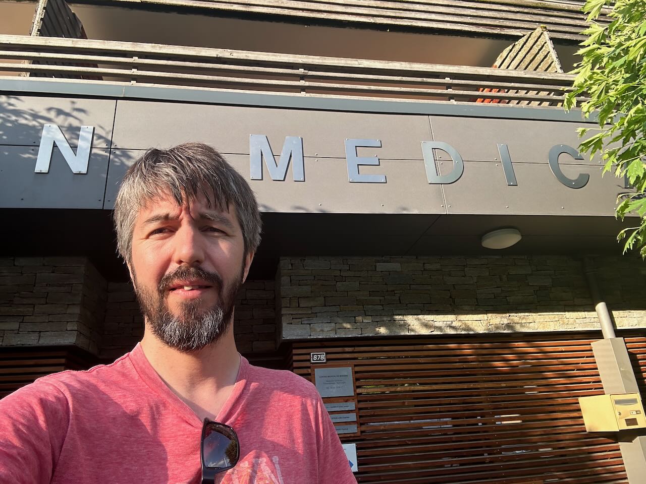 Photo of me standing in front of a building with the lettering 'MEDIC' above it